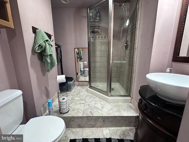 bathroom with tile patterned flooring, toilet, walk in shower, and vanity