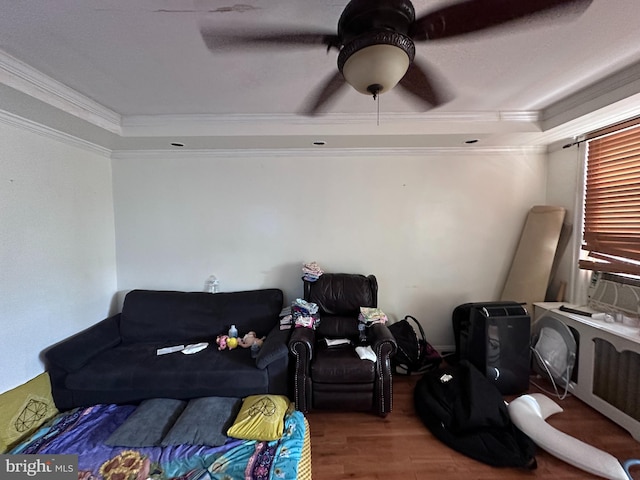 interior space with hardwood / wood-style flooring, a raised ceiling, crown molding, and ceiling fan