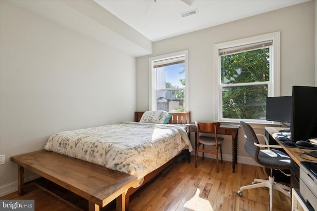 bedroom with hardwood / wood-style floors and ceiling fan