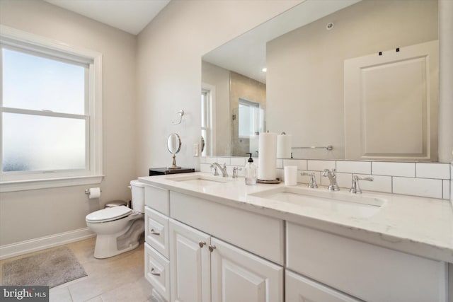 bathroom with tile patterned flooring, vanity, toilet, and tasteful backsplash