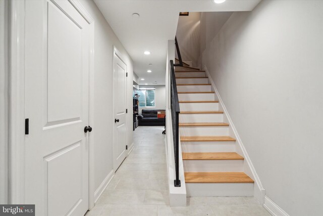 stairs with tile patterned flooring