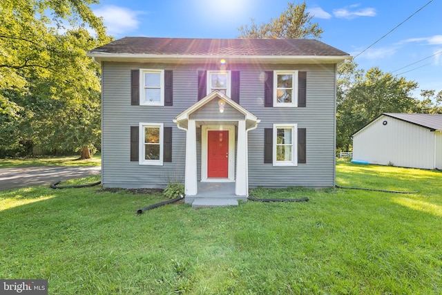 colonial inspired home with a front lawn