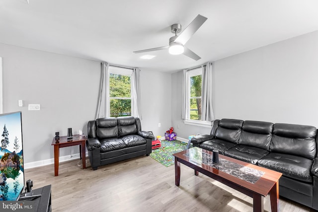 living room with light hardwood / wood-style flooring and ceiling fan