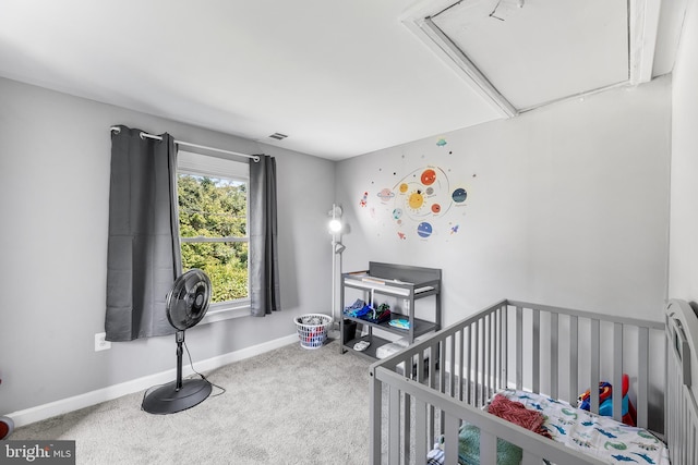 bedroom with carpet and a nursery area