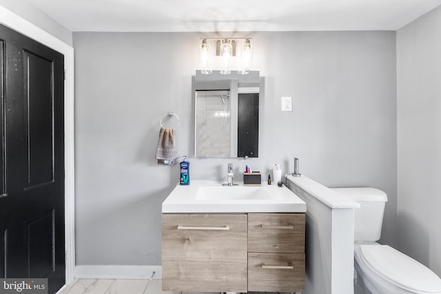 bathroom featuring tile patterned flooring, toilet, and vanity