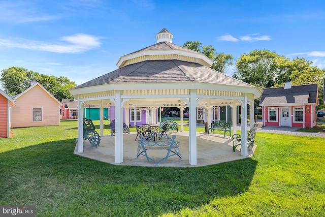 view of property's community with a lawn and a patio