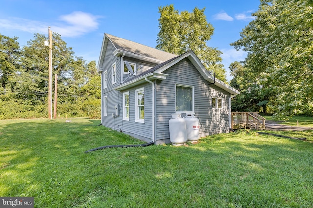 view of side of property with a lawn