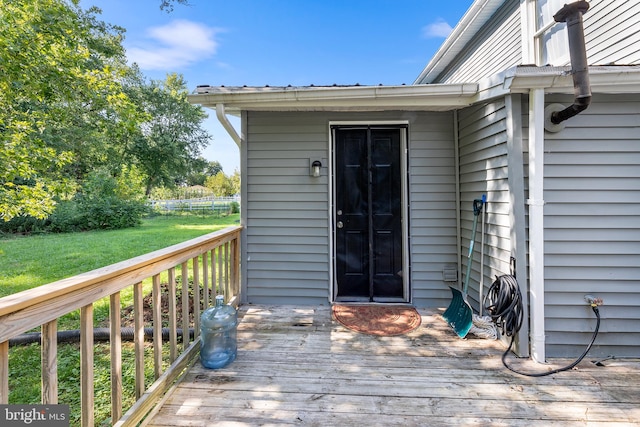 wooden deck featuring a yard