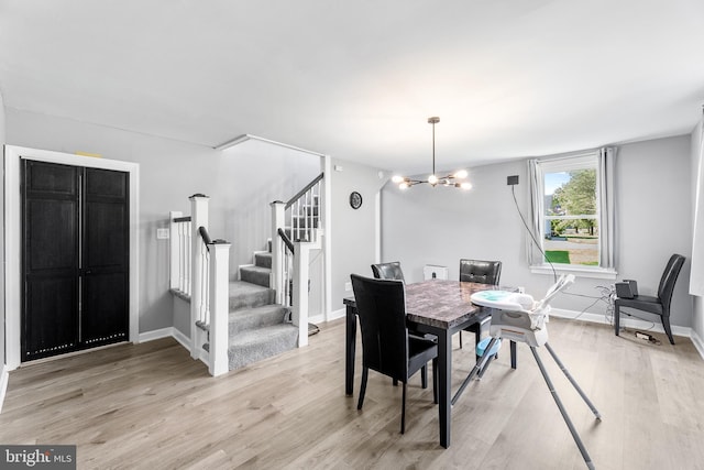 dining area featuring light hardwood / wood-style flooring and a chandelier