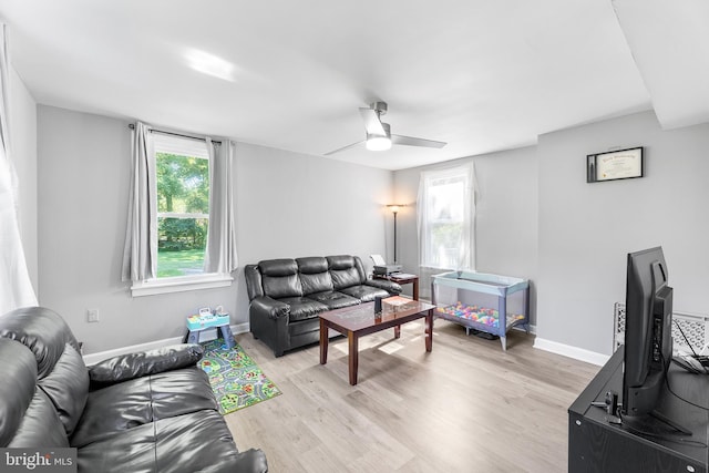 living room featuring light wood-type flooring and ceiling fan