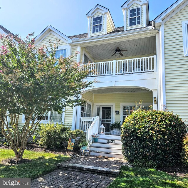 exterior space with ceiling fan and a balcony