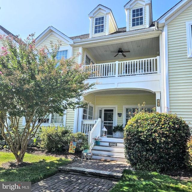 view of front of house featuring a ceiling fan, a porch, and a balcony