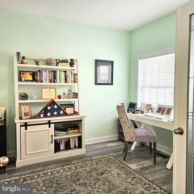 office area featuring dark wood-type flooring and baseboards