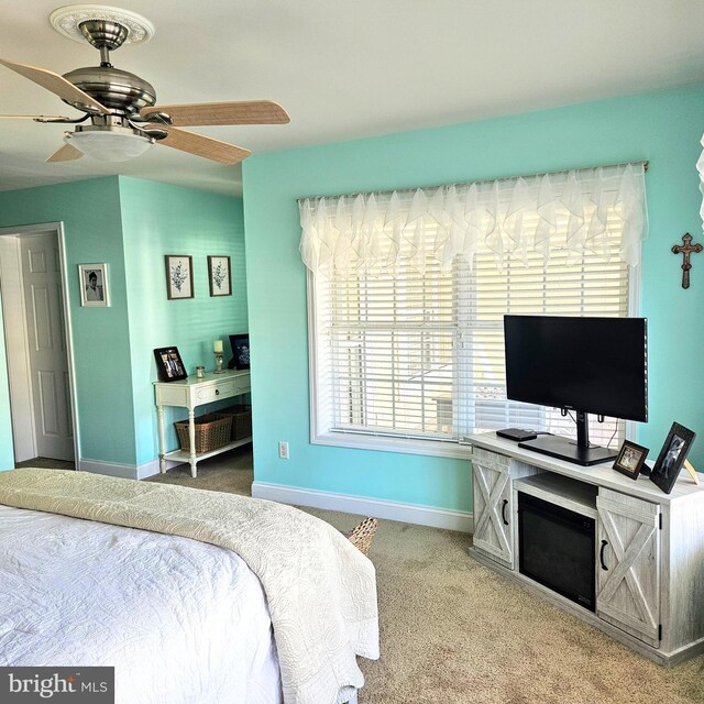 bedroom featuring ceiling fan and light carpet