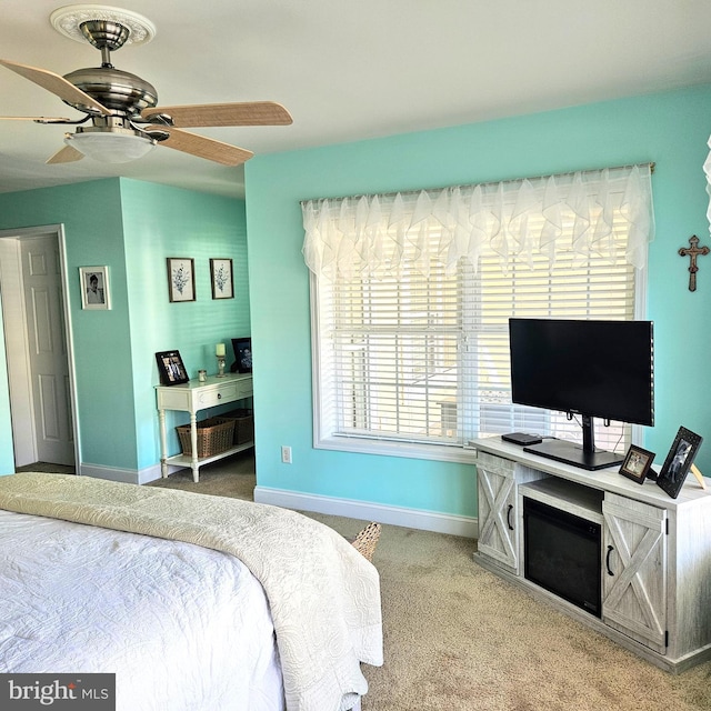 bedroom featuring carpet flooring, a ceiling fan, and baseboards