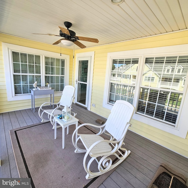 wooden deck featuring ceiling fan