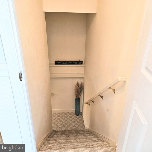 stairway featuring tile patterned flooring