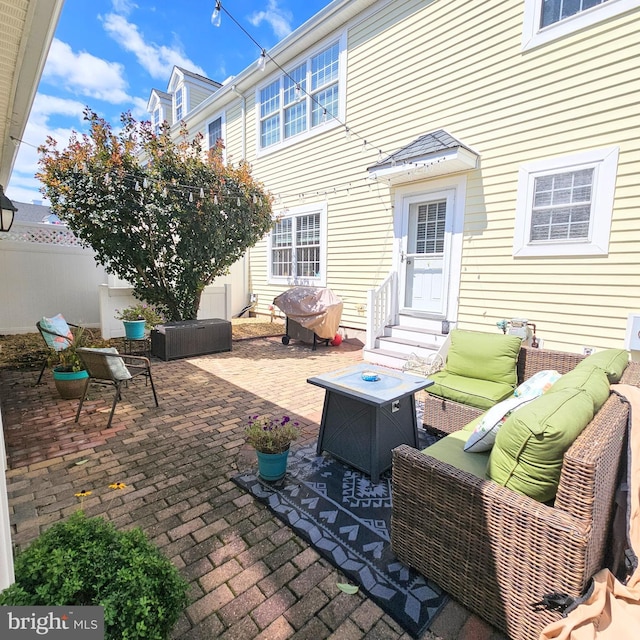 view of patio with entry steps, grilling area, an outdoor living space with a fire pit, and fence