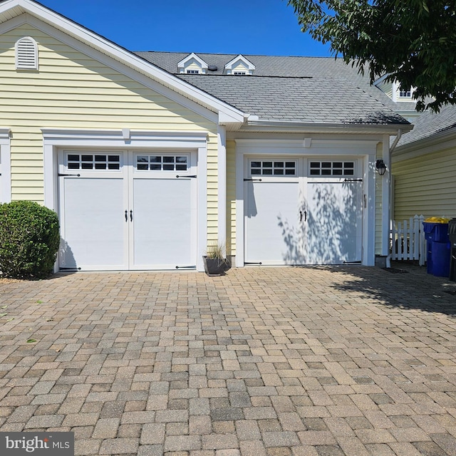 garage featuring decorative driveway