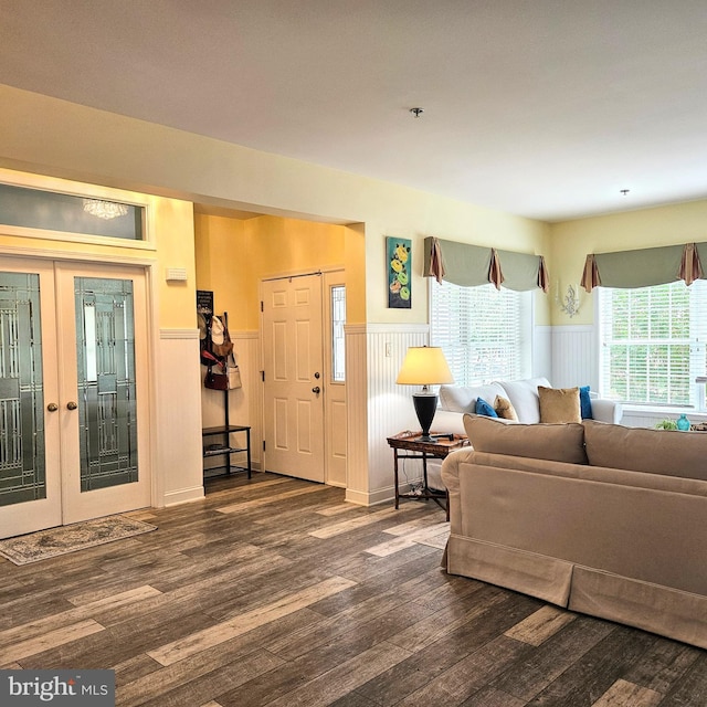 living room with dark wood-type flooring and french doors