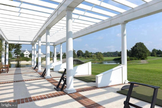 surrounding community featuring a water view, a pergola, and a yard