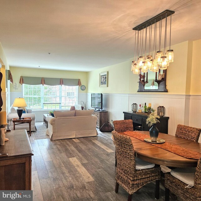 dining space with a notable chandelier and wood-type flooring