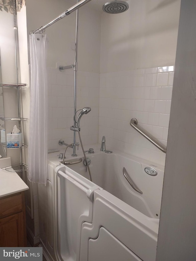 full bathroom featuring vanity and shower / bathtub combination with curtain