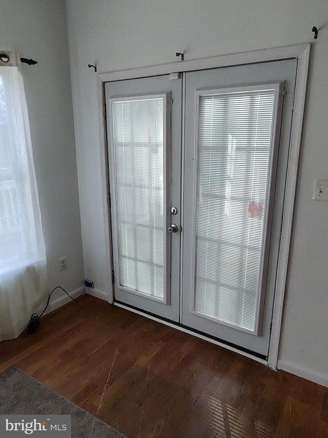 entryway with french doors, plenty of natural light, and dark wood-type flooring