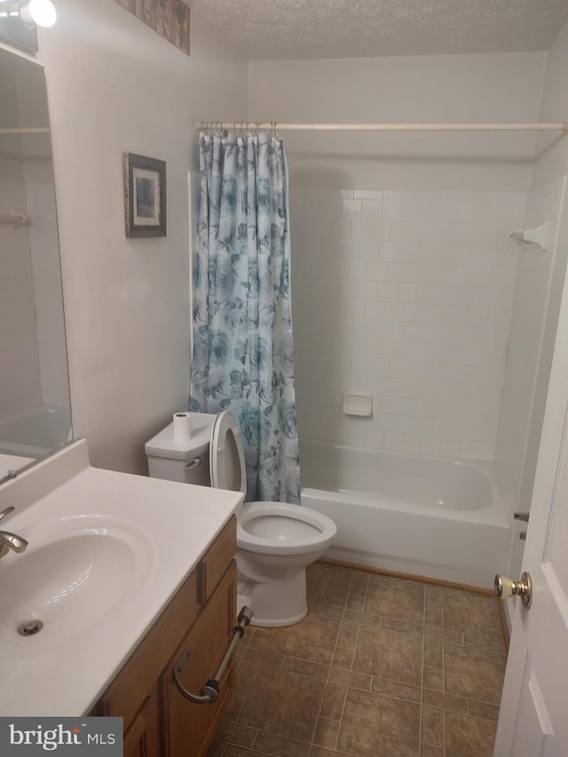 full bathroom with toilet, vanity, a textured ceiling, and shower / tub combo with curtain