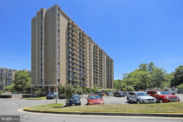 view of building exterior with uncovered parking