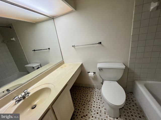 full bathroom with tiled shower / bath combo, toilet, tile patterned floors, and vanity