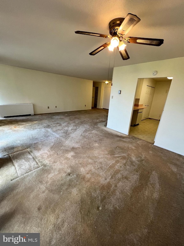 unfurnished bedroom with ensuite bath, ceiling fan, and light carpet