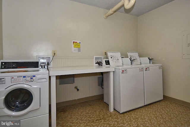 common laundry area featuring light floors, baseboards, and washer and dryer