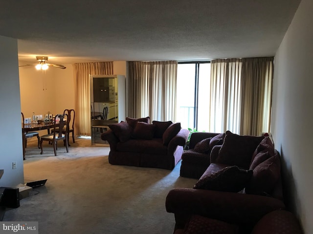 living room featuring ceiling fan and carpet flooring