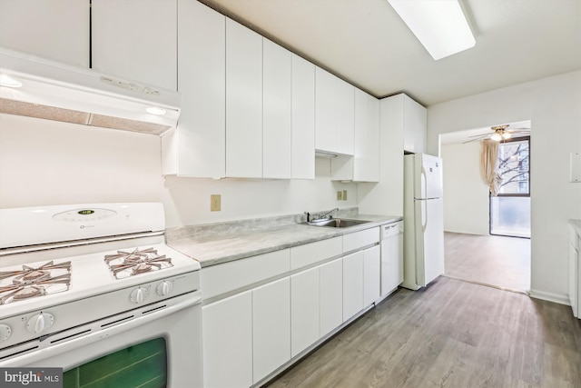 kitchen featuring under cabinet range hood, white appliances, a sink, white cabinetry, and light countertops