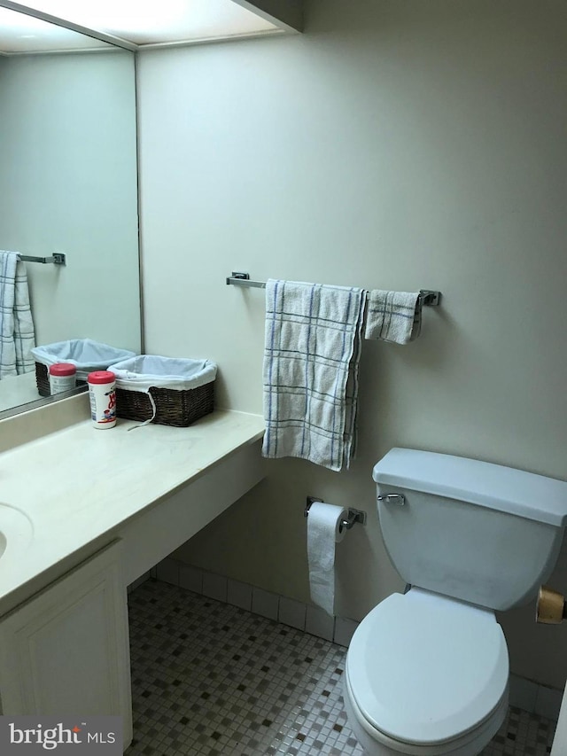 bathroom featuring toilet, vanity, and tile patterned floors