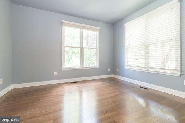 empty room with hardwood / wood-style flooring