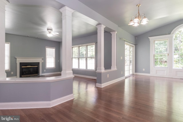 unfurnished living room featuring dark hardwood / wood-style flooring, ornate columns, ceiling fan with notable chandelier, and lofted ceiling