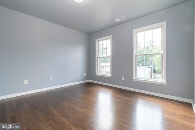 spare room featuring dark hardwood / wood-style floors