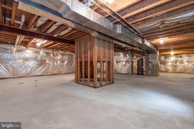 basement featuring heating unit and electric water heater