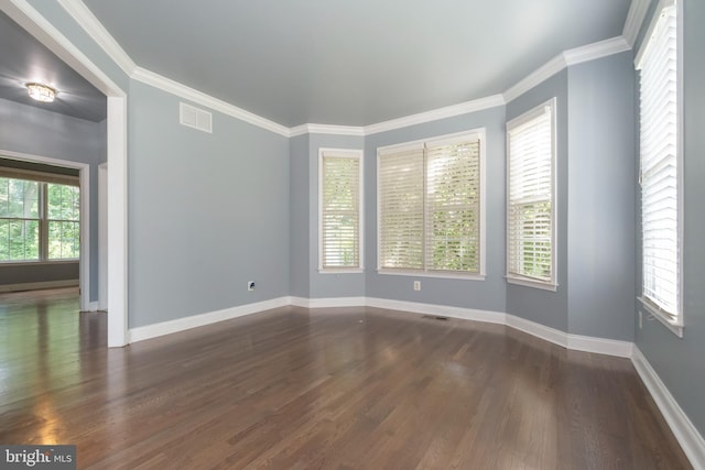 unfurnished room featuring crown molding and dark hardwood / wood-style flooring