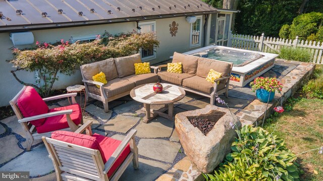 view of patio / terrace with an outdoor living space and an outdoor hot tub