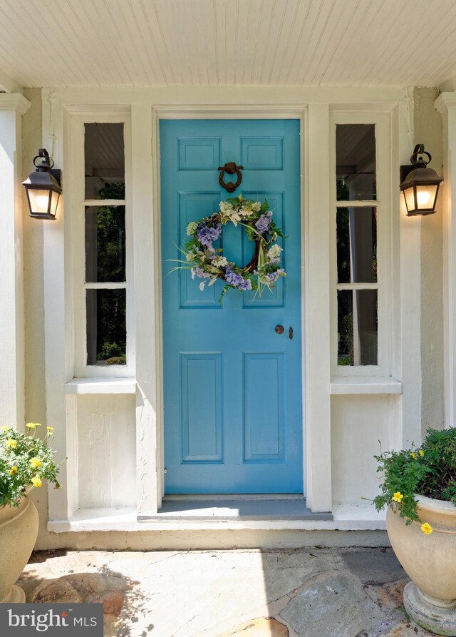 view of exterior entry featuring a porch