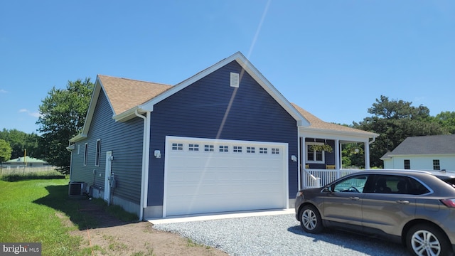 view of side of home with central AC and a garage