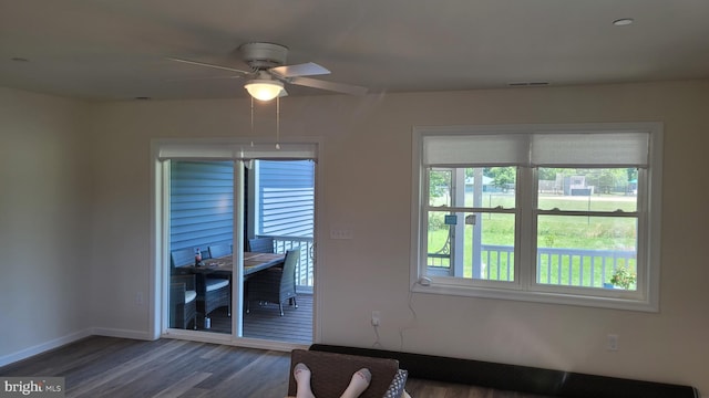 empty room with dark hardwood / wood-style flooring and ceiling fan