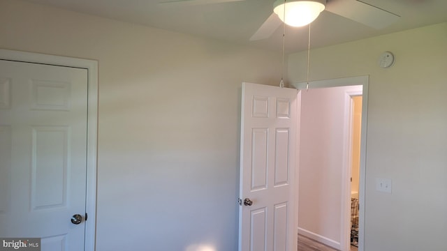 unfurnished bedroom featuring ceiling fan and hardwood / wood-style flooring