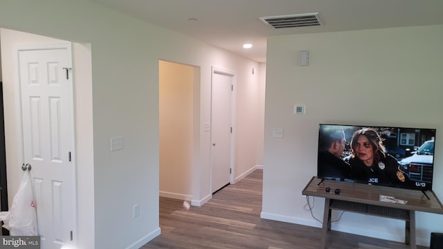 hall with hardwood / wood-style floors