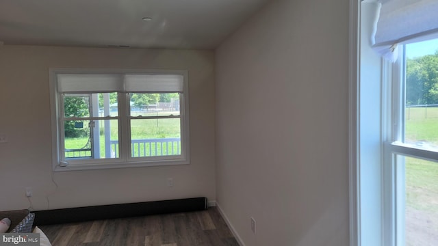 empty room with dark hardwood / wood-style flooring