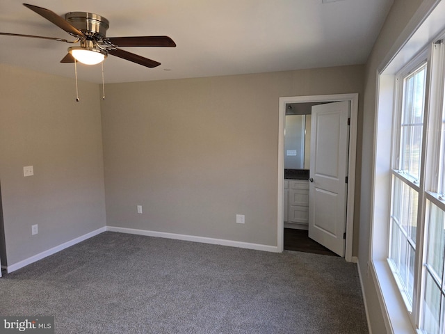 carpeted spare room with ceiling fan