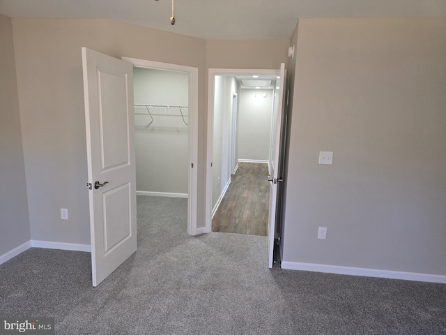 unfurnished bedroom featuring carpet floors and a closet